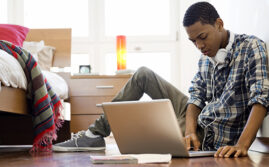 Black teen using laptop