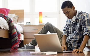 Black teen using laptop