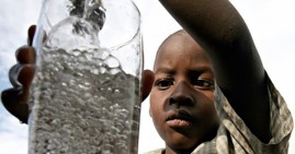 Low income boy drinking water