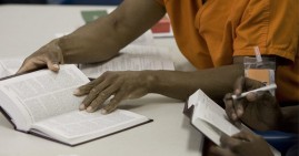 Prisoner reading New Jim Crow book