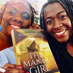 Dr. Ava Eagle Brown during a book signing with a fan
