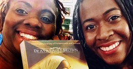 Dr. Ava Eagle Brown during a book signing with a fan