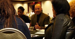 J.R. Fenwick, founder of FLip That Stock, teaching a group of women entrepreneurs how to invest in the stock market
