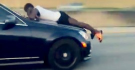 Junior Francis holding on to the front of his ex-girlfriend's car on the highway