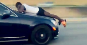 Junior Francis holding on to the front of his ex-girlfriend's car on the highway