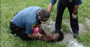 Police restrain 10-year-old boy to the ground