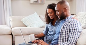 Black couple working on laptop