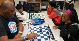 Orrin Hudson, founder of Be Someone, teaching children how to play chess