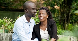 Black married couple sitting in a park