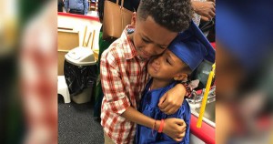 Derek and Charlee Smith hug during Kindergarten graduation