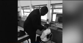 Robert Dunham, teacher giving his student a haircut