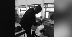 Robert Dunham, teacher giving his student a haircut