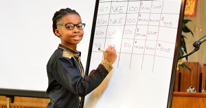 Kamari Chisolm discussing how to calculate gains/losses from stock purchases.