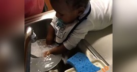 9-month old baby washing dishes