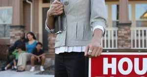 African American family in front of new house