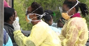 Black women doctors administering COVID-19 tests