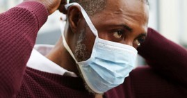 Black man with coronavirus wearing face mask