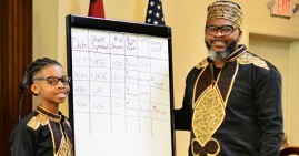 Kevon Chisholm and his son, Kamari, teaching others how to invest