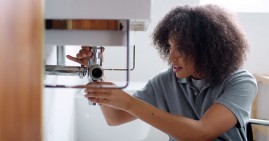 Woman fixing plumbing