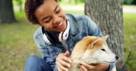 African American girl holding dog