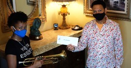 Trumpeter Jazz Henry receives check for Knoma Grant