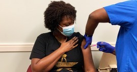Black woman receiving vaccine