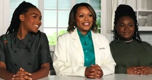 Dr. Kela with two Black teen girls