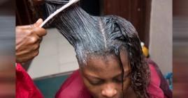 Black woman getting hair relaxers