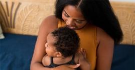 Black woman breastfeeding her baby