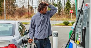 Black man pumping gas