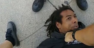 Homeless Black man being stomped by police