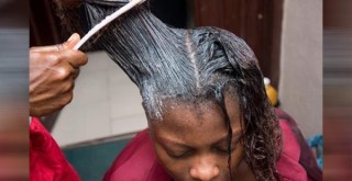 Black woman getting hair relaxers